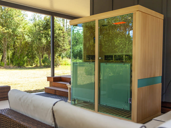 Evolve 30 Infrared Sauna in Outdoor Covered Space Sun Stream Evolve 30 Infrared Sauna set up outdoors under a covered patio, offering a luxury sauna experience at home.